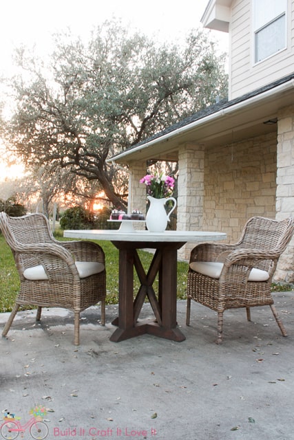 another picture of the round outdoor dining table with wicker chairs